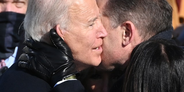 Joe Biden (L) embraces son Hunter