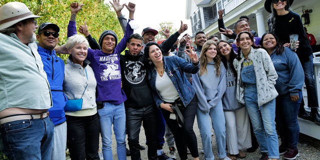 Migrants pose with Martha's Vineyard volunteers