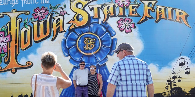 People take photos with the Iowa State Fair sign