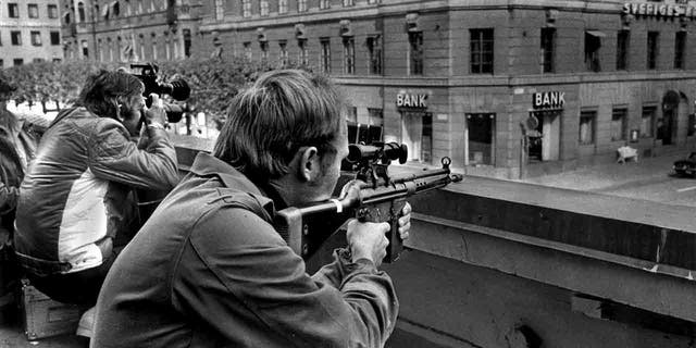 Sniper and photographer outside the bank in Stockholm