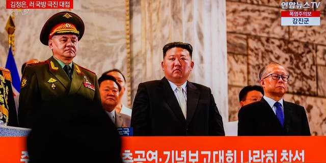 Kim Jong un watches military parade