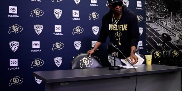 Deion Sanders speaks to reporters