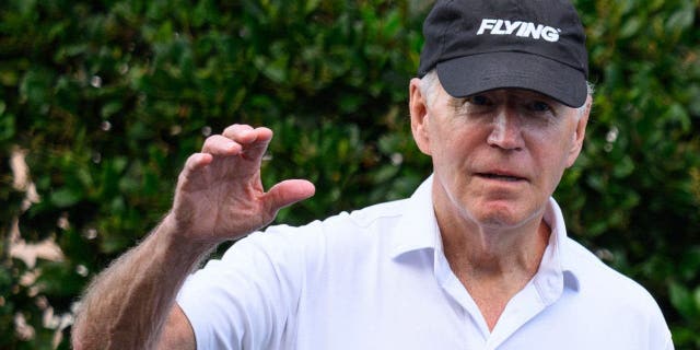 President Joe Biden waves