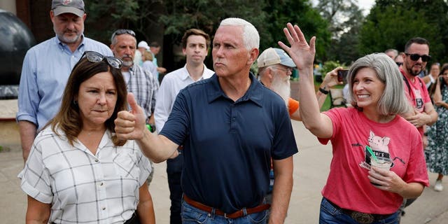 Mike Pence (C) and his wife Karen Pence (L) and Sen. Joni Ernst (R-IA)