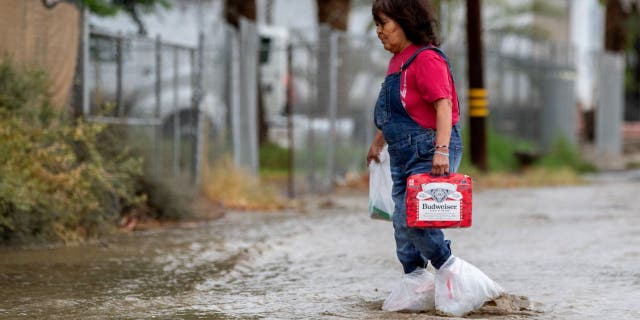 Woman walking in California flood