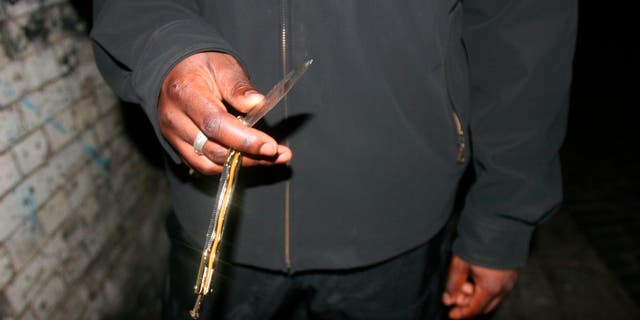 close-up on man holding butterfly knife in hand