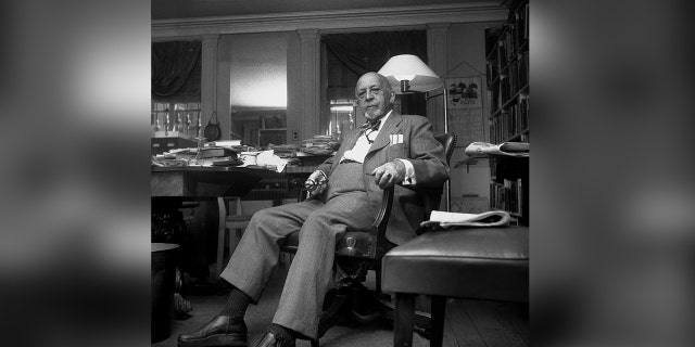 W.E.B. Du Bois seated at desk