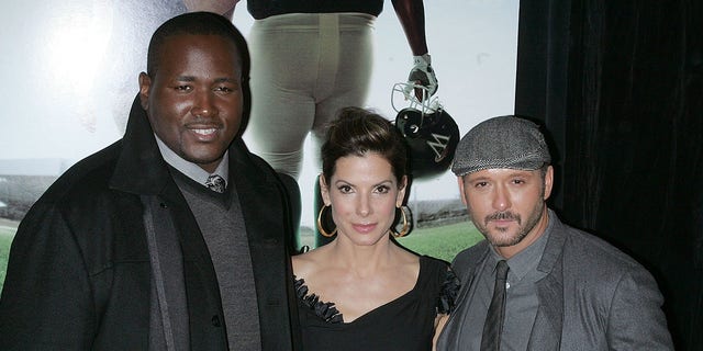 Quinton Aaron, Sandra Bullock and Tim McGraw at a premiere for "The Blind Side"