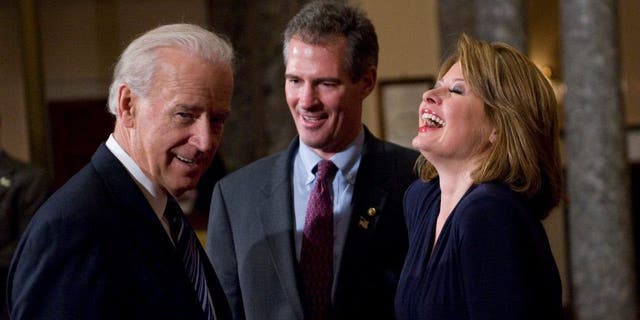 Sen. Scott Brown participates in a ceremonial swearing in with his wife Gail Huff and Vice President Joe Biden