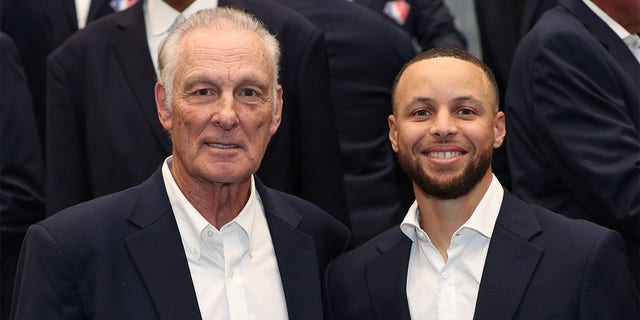 Rick Berry and Steph Curry pose for a photp
