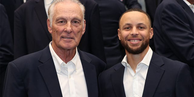 Rick Berry and Steph Curry pose for a photp