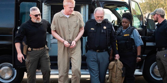 Alex Murdaugh in a prison jumpsuit being escorted by police
