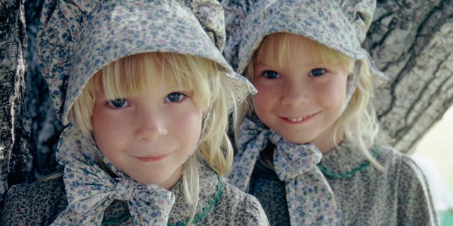 A close-up of Wendi Lou Lee and her twin sister in costume as baby grace ingalls
