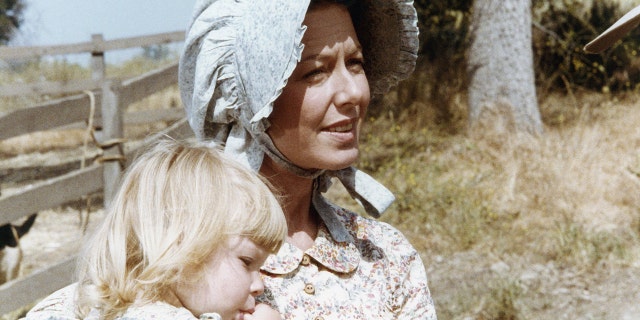 Karen Grassle holding onto either Brenda or Wendi in costume