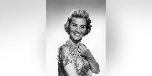 Rose Marie posing in a portrait for The Dick Van Dyke Show in a floral dress
