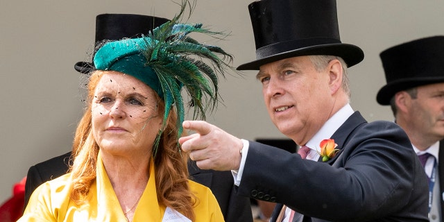 Sarah Ferguson wearing a yellow dress and a green hat standing next to Prince Andrew in a suit and top hat