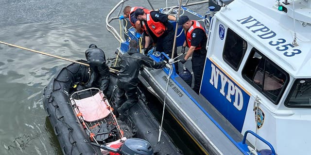 NYPD boats in the water coordinate to lift the body onto the boat
