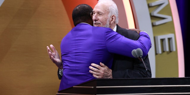 Ahmad Rashad hugs Gregg Popovich