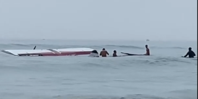 Small plane submerged in water at New Hampshire beach