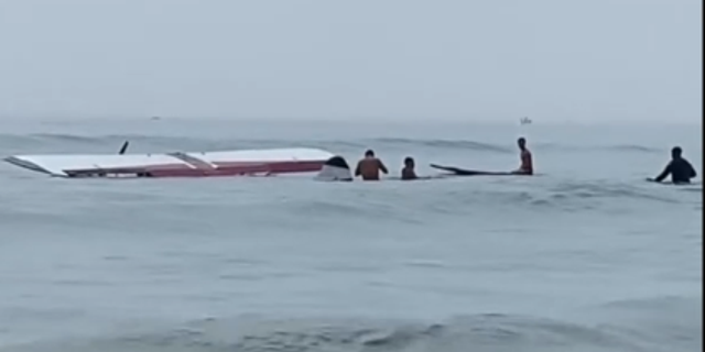 Small plane submerged in water at New Hampshire beach