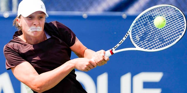 Iga Swiatek hits a ball