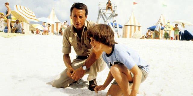 Roy Scheider and Marc Gilpin on the beach in "Jaws 2"