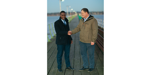 attorney Jeremiah Ingunnbole, left, shaking hand of Adam Smith-Connor