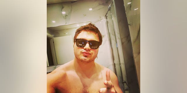 John Daniels in a Facebook selfie, shirtless wearing sunglasses