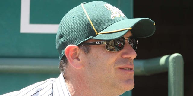 John Fisher watches an Oakland Athletics game