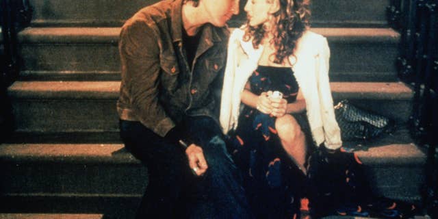 John Corbett sitting next to Sarah Jessica Parker in a scene from Sex and the City