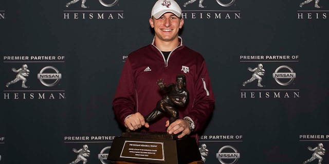 Johnny Manziel holds the Heisman Trophy