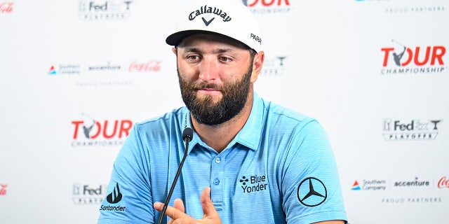 Jon Rahm talks to reporters