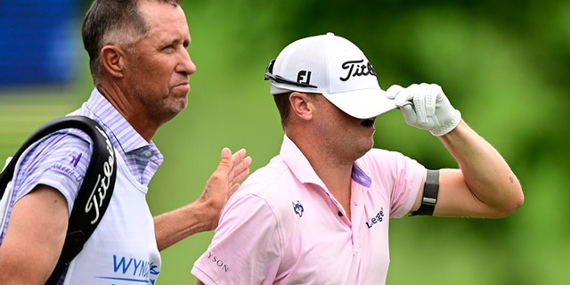 Justin Thomas reacts with caddie