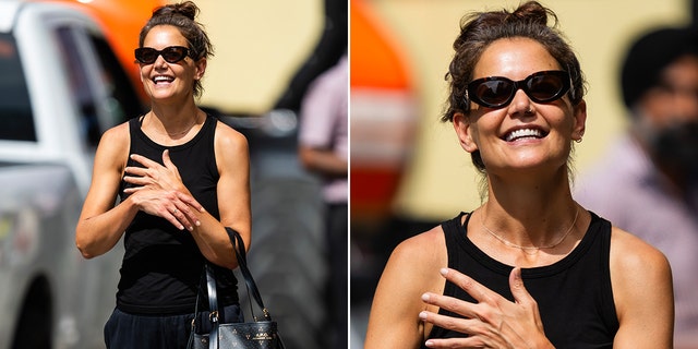 Katie Holmes smiling as she walks through New York