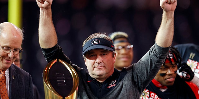 Kirby Smart holds the trophy