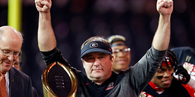 Kirby Smart holds the trophy