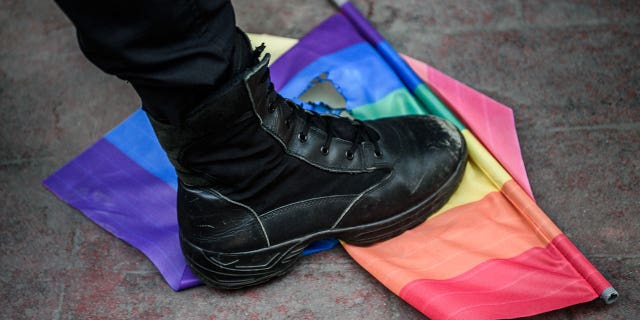 A foot over an LGBT flag