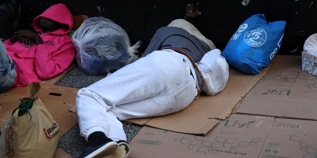 Migrants sleep outside Rosevelt hotel