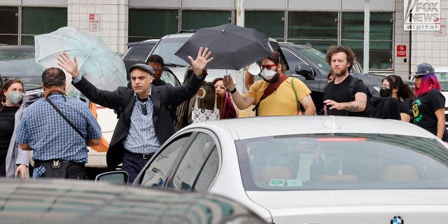 Machete professor is flanked by an entourage