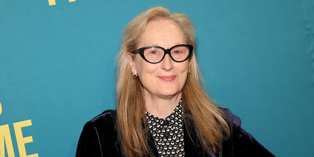 Meryl Streep on the red carpet wearing black framed glasses