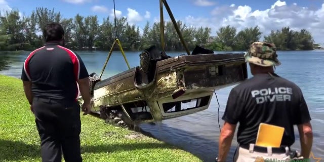 Pictured is a police handout of an old car being pulled from a lake in Doral, Florida