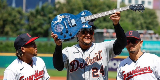Miguel Cabrera holds up guitar
