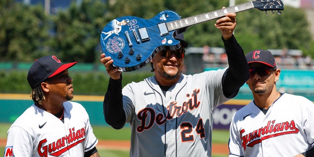 Miguel Cabrera holds up guitar