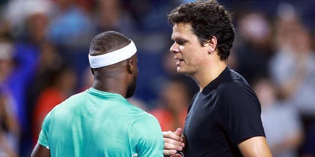 Milos Raonic and Frances Tiafoe shake hands