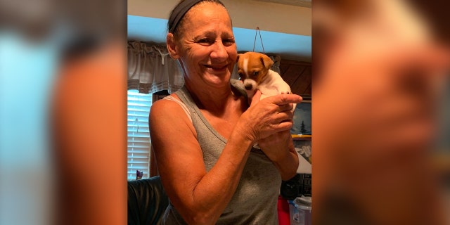 Missing New Jersey grandma Norma Yates poses with a puppy