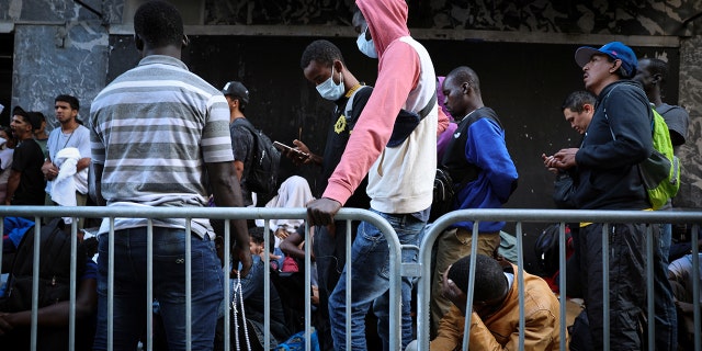 Migrants wait outside New York City hotel