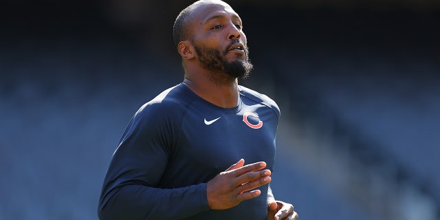 Robert Quinn warms up before a game