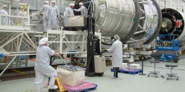 People work on Northrop Grumman’s 19th commercial resupply services mission