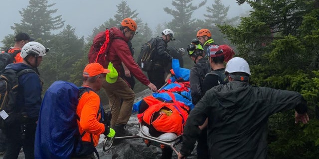rescuers carrying injured hiker