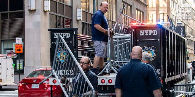 Officials unload additional barricades outside of the Roosevelt Hotel
